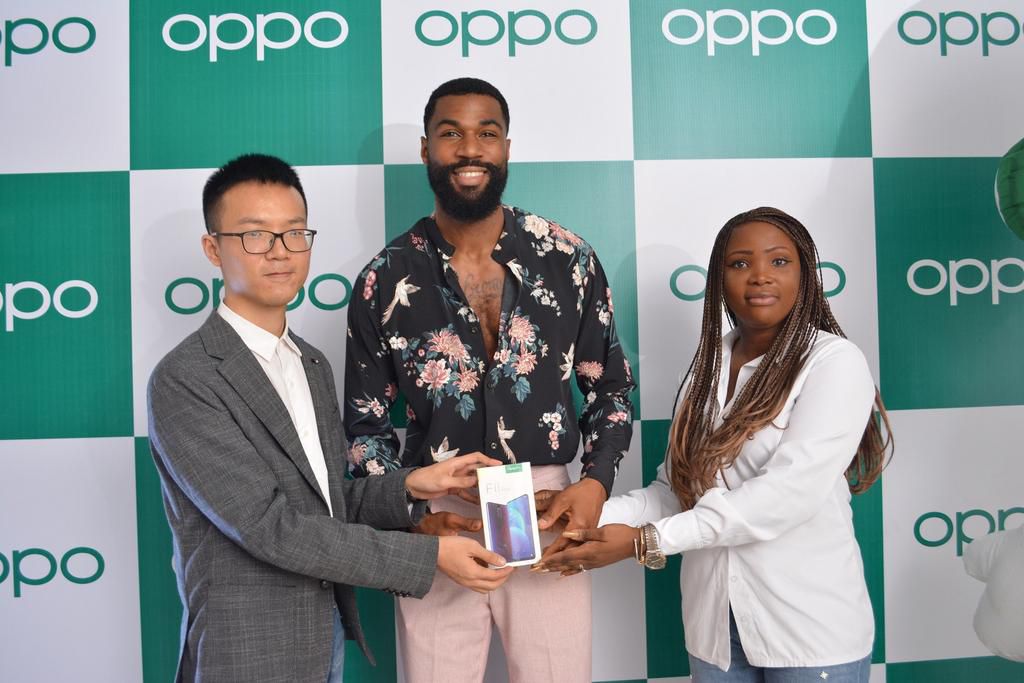 LEFT, Kris Cao, Marketing Director OPPO Nigeria and RIGHT, Nengi Akinola, Marketing Manager, OPPO Nigeria gifiting the OPPO F11 Pro to Mike at the OPPO Head Office, Lagos