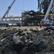 Saudi engineers use cranes to remove the mangled wreckage of production machinery at the Khurais oilfield, one of two facilities hit by dramatic drone and missile strikes last Saturday