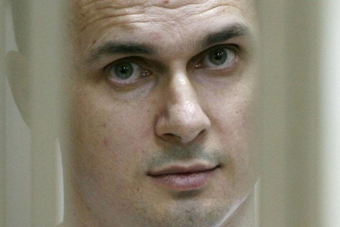 File photo taken in July 2015 shows Ukrainian film director Oleg Sentsov looking out from his defendants' cage during a hearing at a military court in Russia. He was among prisoners exchanged with Russia on Saturday.