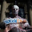 View of a vandalized statue with a banner reading "Dignified education" during protests against the Chilean government on October 29, 2019