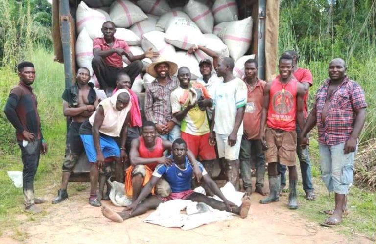 Mr. Ekene Uzodinma, the farmer and his rice farm workers after harvesting. [NAN]