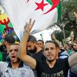 Algerian protesters, with the Berber flag in the background, chant slogans during anti-government demonstrations in the capital Algiers
