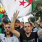 Algerian protesters, with the Berber flag in the background, chant slogans during anti-government demonstrations in the capital Algiers