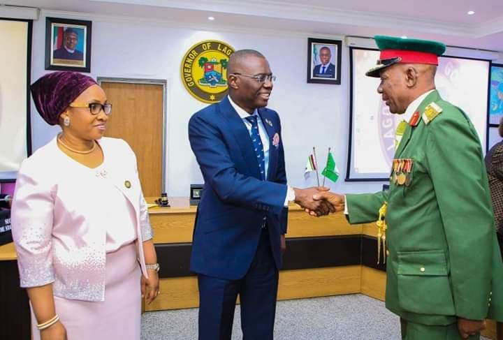 Lagos State Governor, Mr. Babajide Sanwo-Olu (middle) being decorated with the Armed Forces Remembrance Day Emblem by the Chairman, Nigerian Legion, Lagos State Chapter, Col. Samuel Akande (Rtd) (right), while Commissioner for Home Affairs, Mrs Uzamat ...