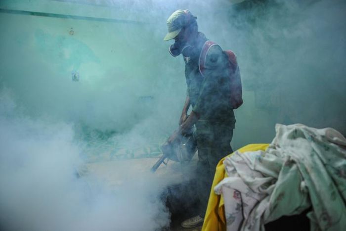 A member of the Cuban army fumigates against the Aedes aegypti mosquito to prevent the spread of Zika, chikungunya and dengue, in Havana, on February 23, 2016