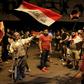Iraqi protesters wave the national flag as they take part in anti-government demonstrations in central Baghdad's Tahrir Square