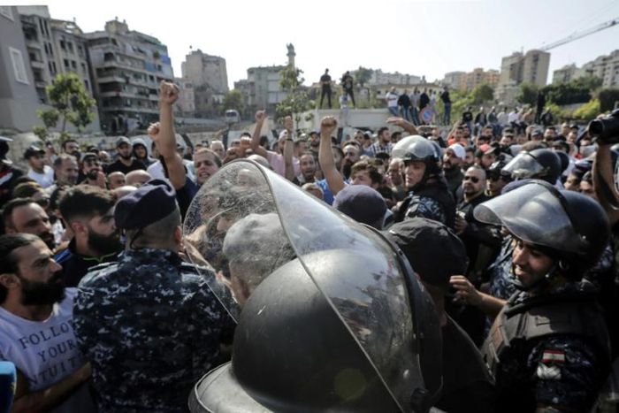 Riot police deployed after counter-demonstrators wielding sticks and throwing stones attacked the Beirut protest site