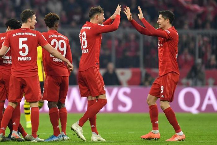 Bayern Munich's Polish striker Robert Lewandowski (R) celebrates with team-mate Leon Goretzka during the rout of Dortmund on Saturday.