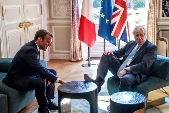 For one brief moment -- immortalised by photographers -- Johnson leant back in his chair and placed the sole of his right foot on a table as he sat down for talks with Macron