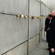 German Chancellor Angela Merkel leaving a tribute in a preserved segment of the Berlin Wall in 2014