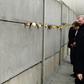 German Chancellor Angela Merkel leaving a tribute in a preserved segment of the Berlin Wall in 2014