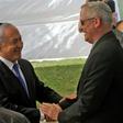 Israeli Prime Minister Benjamin Netanyahu (L) greets rival Benny Gantz, leader of Blue and White party, at a memorial ceremony for late Israeli president Shimon Peres on Thursday