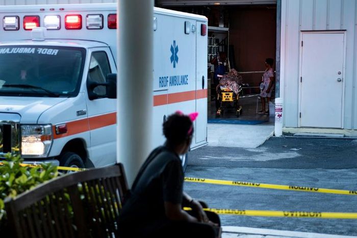 A woman waits as survivors of Hurricane Dorian arrive from Abaco at Lynden Pindling International Airport in the Bahamas