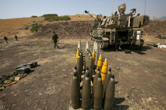 Artillery shells are lined up beside an Israeli self-propelled artillery gun near the Lebanese border