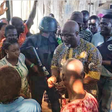 Dino Melaye surrounded by his supporters at the shop of a bean cake seller. (Micheal Odoh/Twitter)