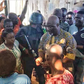 Dino Melaye surrounded by his supporters at the shop of a bean cake seller. (Micheal Odoh/Twitter)