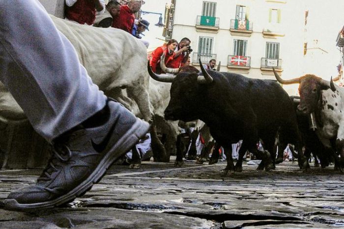 Participants take place in the San Fermin festival running of the bulls in Pamplona, northern Spain in July 2019