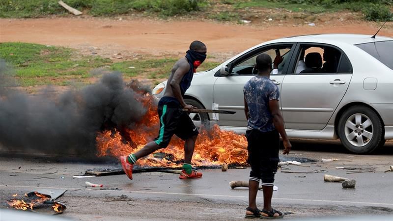 Protesters set tires on fire in Abuja [Afolabi Sotunde/Reuters]