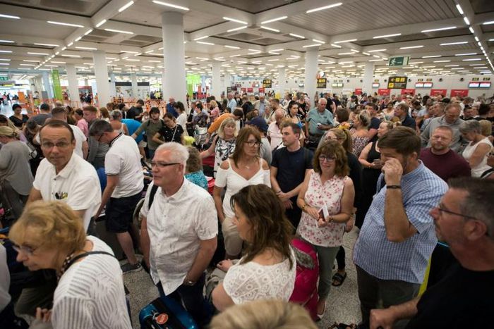 Passengers of British travel group Thomas Cook queue at Son Sant Joan airport in Palma de Majorca, Spain