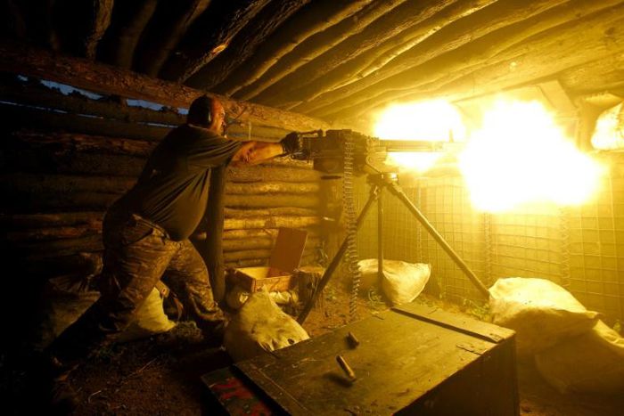 Macron has taken a keen interest in brokering an end to the conflict in the east of Ukraine that began in 2014. Here a Ukrainian serviceman fires a heavy machine gun during fighting with Russian-backed separatists in July
