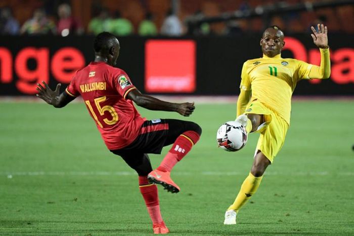 A file photo of Zimbabwe star Khama Billiat (R) playing against Uganda during the 2019 Africa Cup of Nations in Egypt