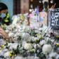 Mourners pay their respects at the site where a student fell to his death during a recent protest