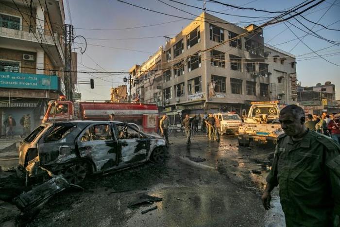 Simultanaous blasts near a busy market and a school in Syria's Kurdish-majority city of Qamishli killed six people and wounded 22
