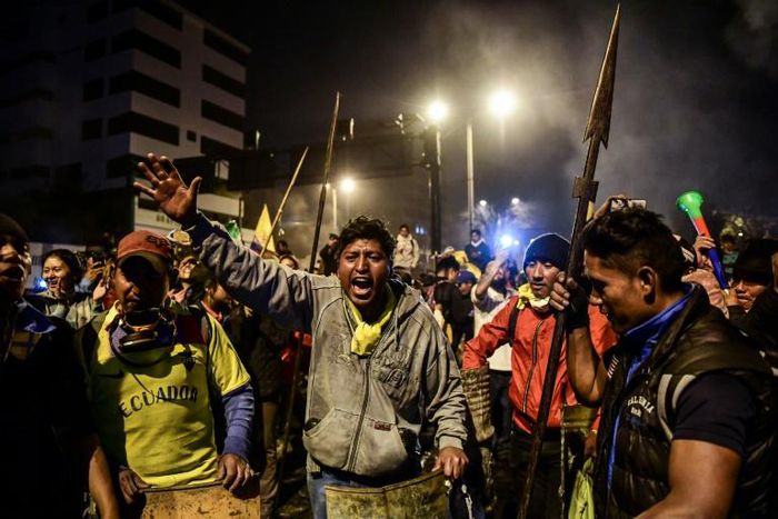 Indigenous people celebrate in Quito on October 13, 2019 after Ecuador's president and indigenous leaders reached an agreement to end violent protests