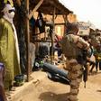 Far from home: A member of France's Barkhane force patrols the market in Menaka, northeastern Mali