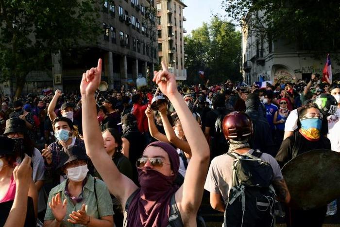 Demonstrators shout slogans during a protest against the government in Santiago on Monday