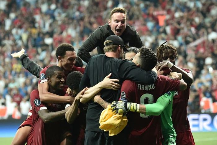 Liverpool players and staff celebrate after beating Chelsea on penalties to win the Super Cup in Istanbul