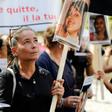 A woman holds the picture of a victim as she takes part in a protest march denouncing violence against women in Paris