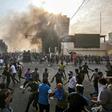 Protesters clash with an Iraqi riot police during a demonstration against state corruption and poor services in Baghdad