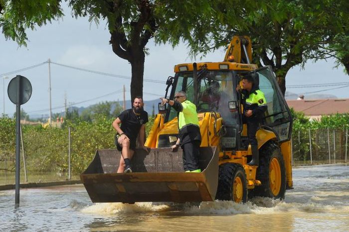 In flooded Redovan, some 50km (30 miles) southwest of Alicante, some people were being evacuated with diggers