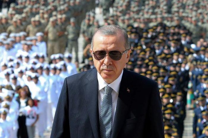 Turkish President Recep Tayyip Erdogan (C) has come under fire for undermining judicial independence