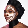 Nigerian visual artist Laolu Senbanjo marks Serena Williams with his signature tribal designs [Credit: Essence]
