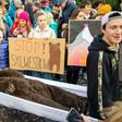 A fake bear on a stretcher during a protest against a New Year's event that some fear will wake hibernating bears
