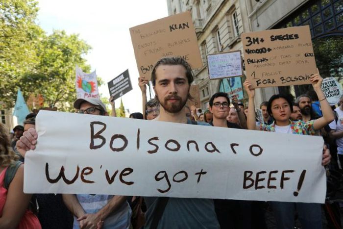 Protesters with a banner that reads "Bolsonaro we've got beef!" block a street at a climate change demonstration in London on August 23, 2019; Finland is now weighing a Brazilian beef ban over Amazon fires