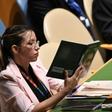 A Venezuelan delegate holds up a book referring to South American independence hero Simon Bolivar while US President Donald Trump addresses the UN General Assembly