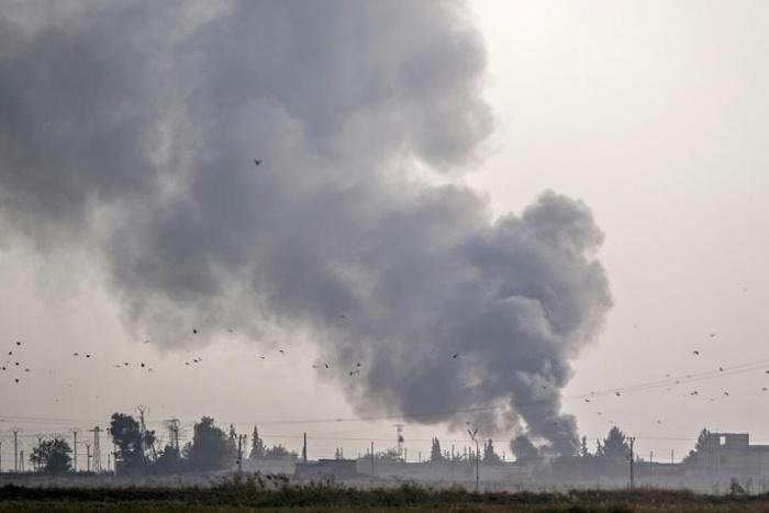 The Turkish military hits Kurdish-controlled towns along the border with air strikes and artillery fire before ground troops cross into Syria
