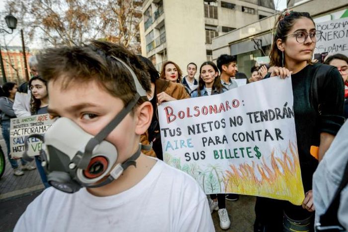 Marchers protest against Brazilian President Jair Bolsonaro over the fires in the Amazon rainforest in front of Brazil's embassy in Santiago, Chile August 23, 2019