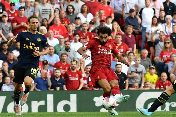 Liverpool's Egyptian midfielder Mohamed Salah (C) shoots to score his second goal, Liverpool's third during the English Premier League football match between Liverpool and Arsenal at Anfield in Liverpool, north west England on August 24, 2019.