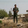 Kurdish security forces stand guard during a demonstration by Syrian Kurds against Turkish threats of a military operation in northern Syria