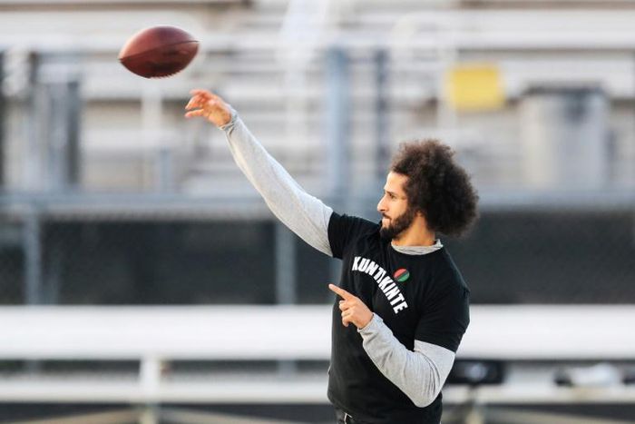 Colin Kaepernick makes a pass during a Saturday workout after ditching an NFL-planned private training session for his own public workout at a nearby high school field