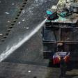 A demonstrator stands in front of police water cannon in Santiago, Chile, which has been rocked by protests