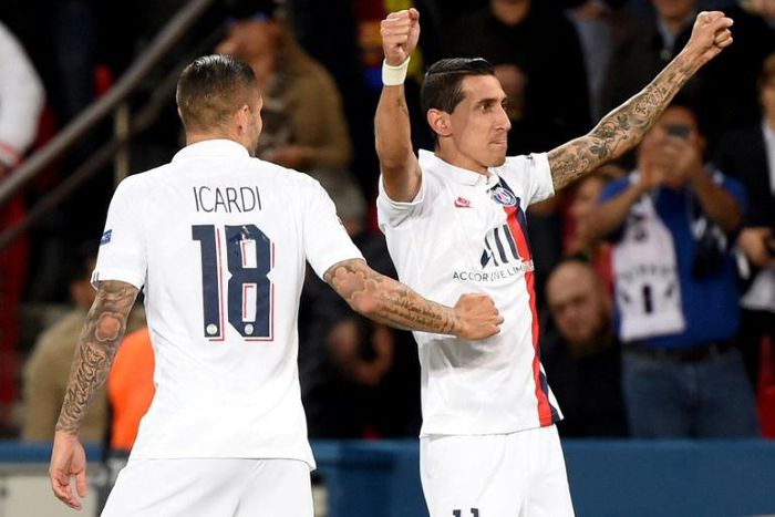 Angel Di Maria celebrates with Mauro Icardi after scoring one of his two goals as Paris Saint-Germain beat Real Madrid 3-0 in their Champions League opener