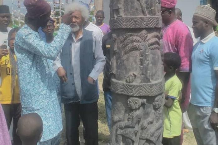 Mr Femi Coker showing Santo Drum to Prof. Wole Soyinka at the Art Gallery in Badagry on Saturday. (NAN)