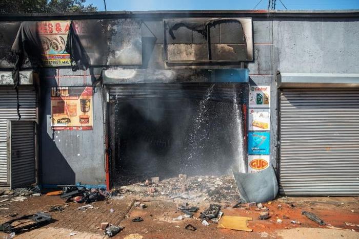 Attacked: The remains of a store in Johannesburg's Malvern area after a night of violence