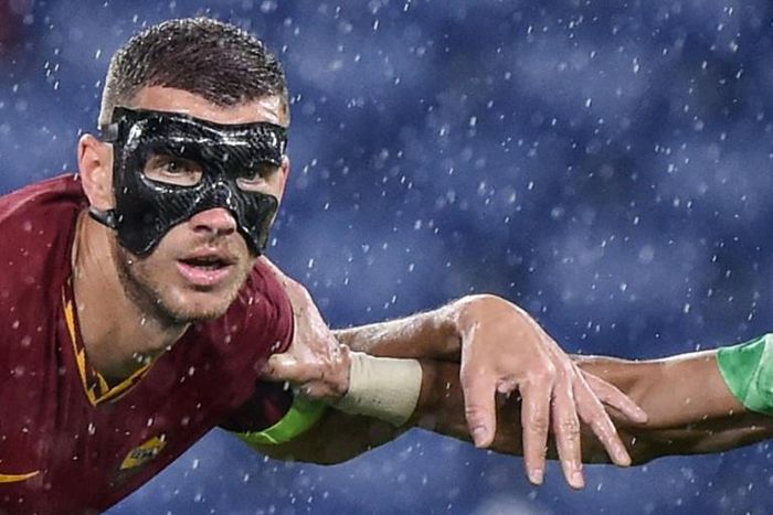 AS Roma's Edin Dzeko wore a protective face mask after breaking his cheekbone.