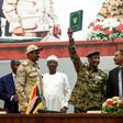 Sudan's protest leader Ahmad Rabie (R), flashes the victory gesture alongside General Abdel Fattah al-Burhan (2nd-R), the chief of the military council, after signing the "constitutional declaration" on Saturday